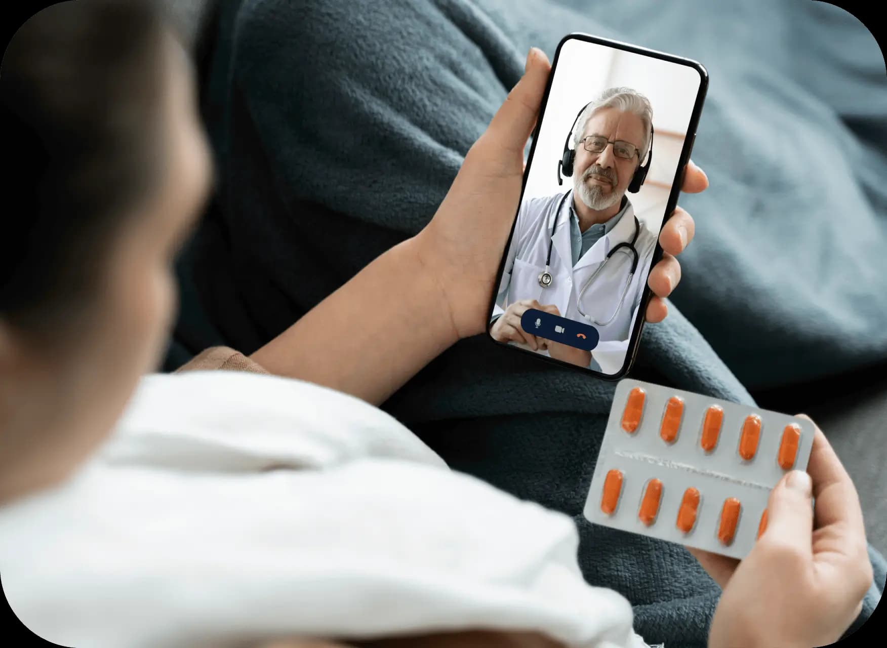 Woman holding tablet with pills, watching doctor on screen.